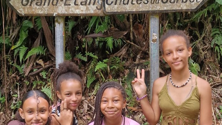 Élèves de l'ASA Guadeloupe en sortie au Grand Étang devant le panneau Chutes du Carbet